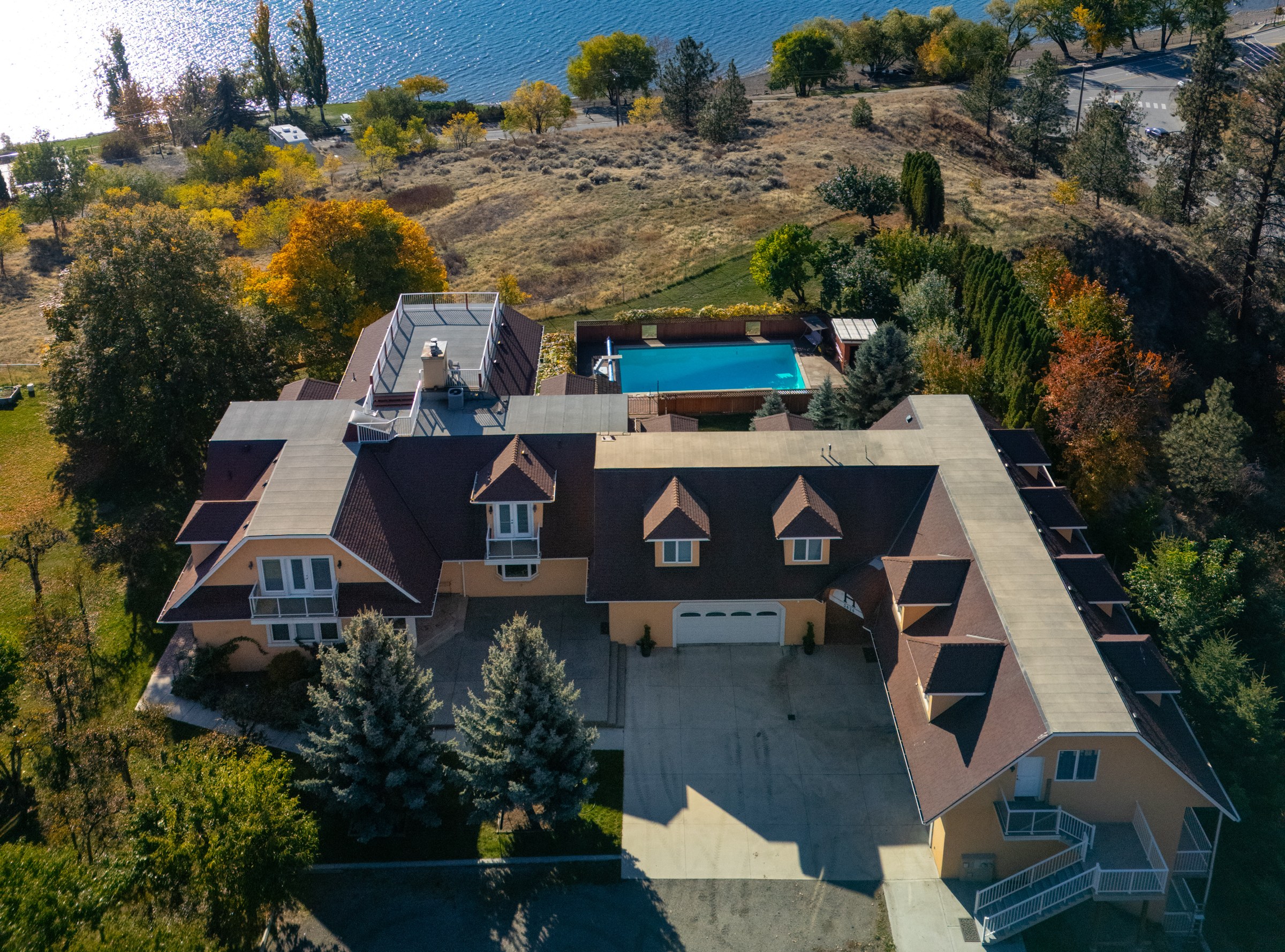 Bird's-eye view directly over the main residence, pool and grounds