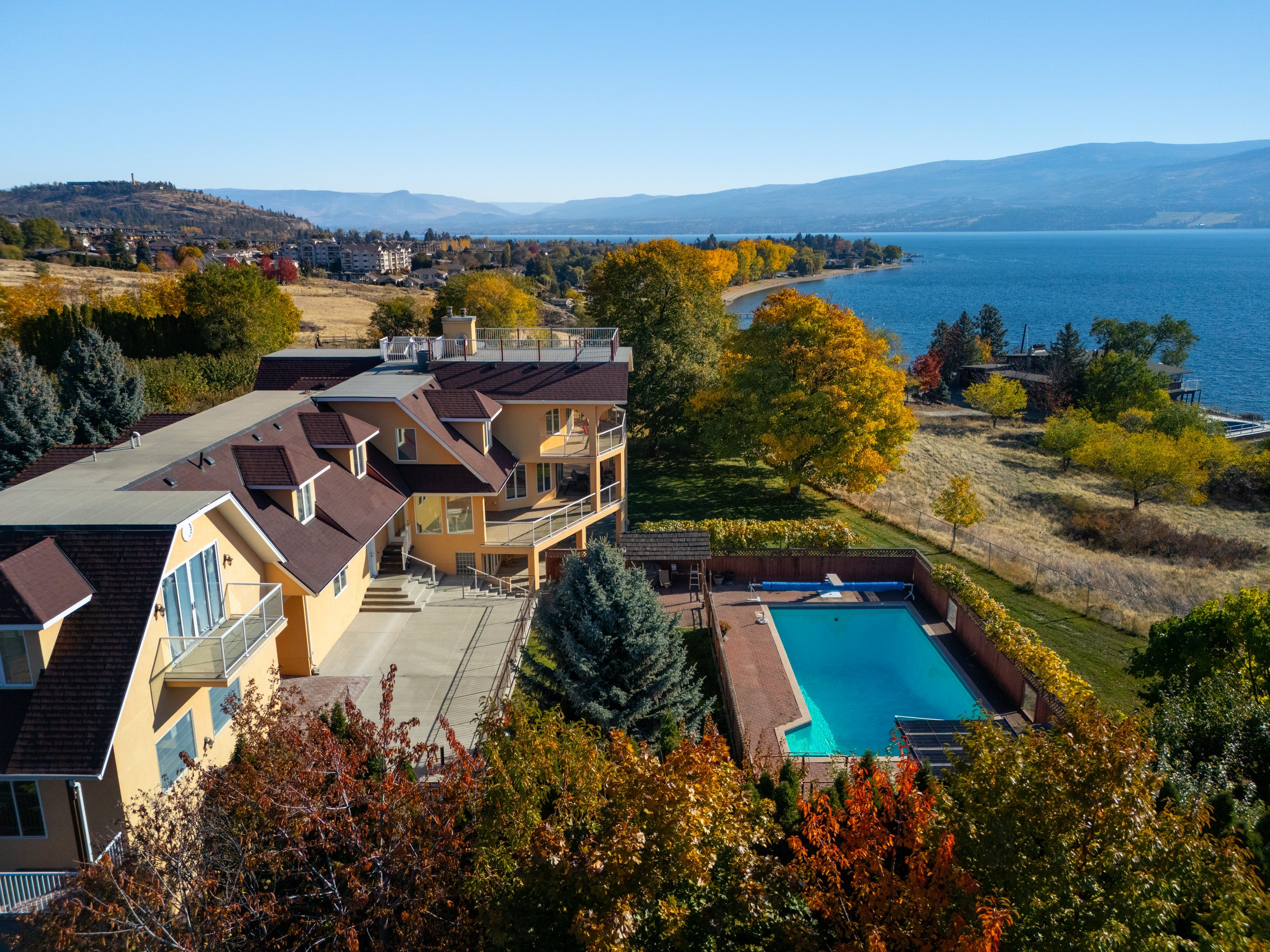 Drone view of 3820 Wetton Road from the front drive, Okanagan Lake behind the house