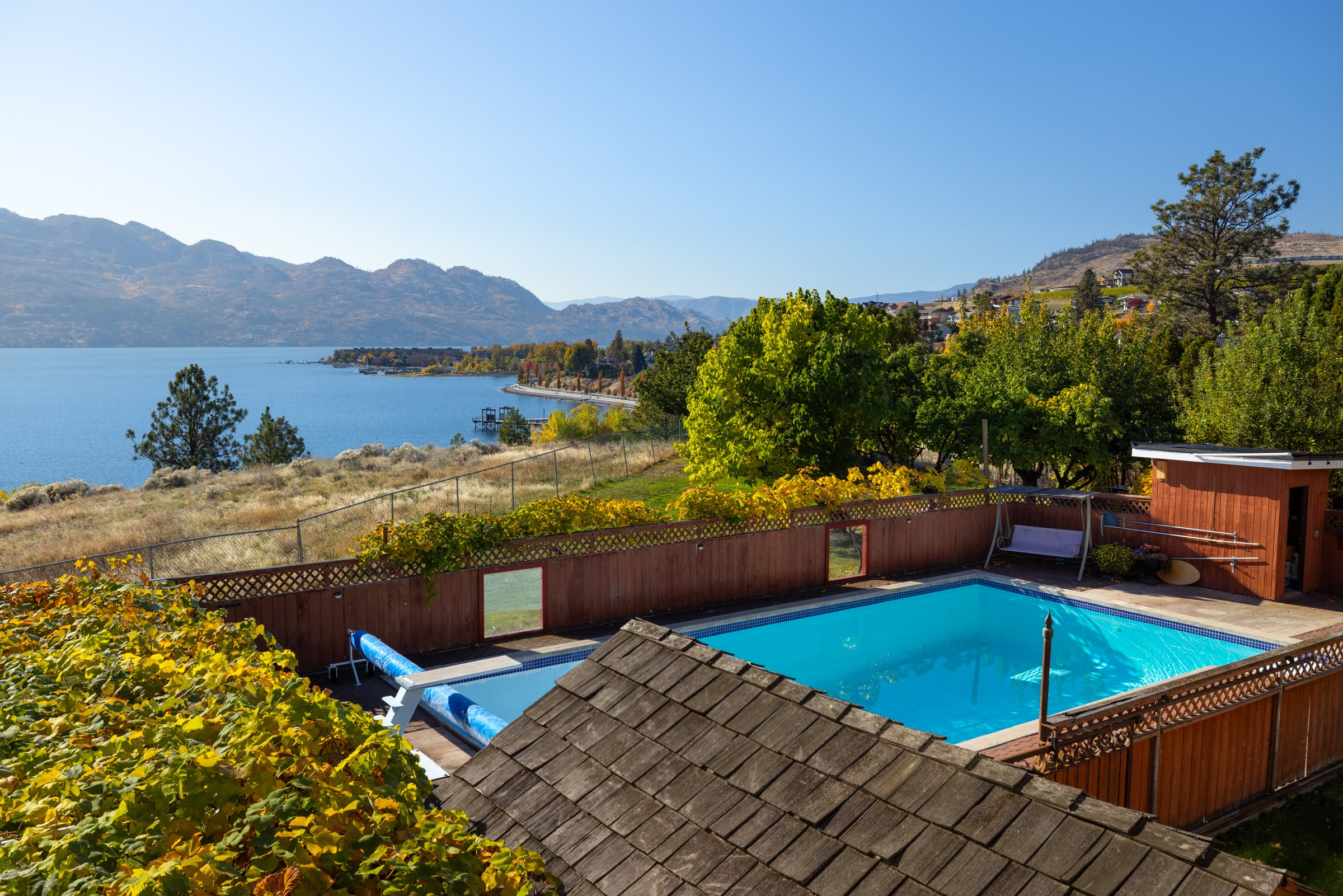 The heated in-ground pool and terrace, with Okanagan Lake behind